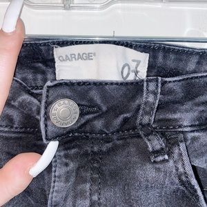 garage, black ripped skinny jeans